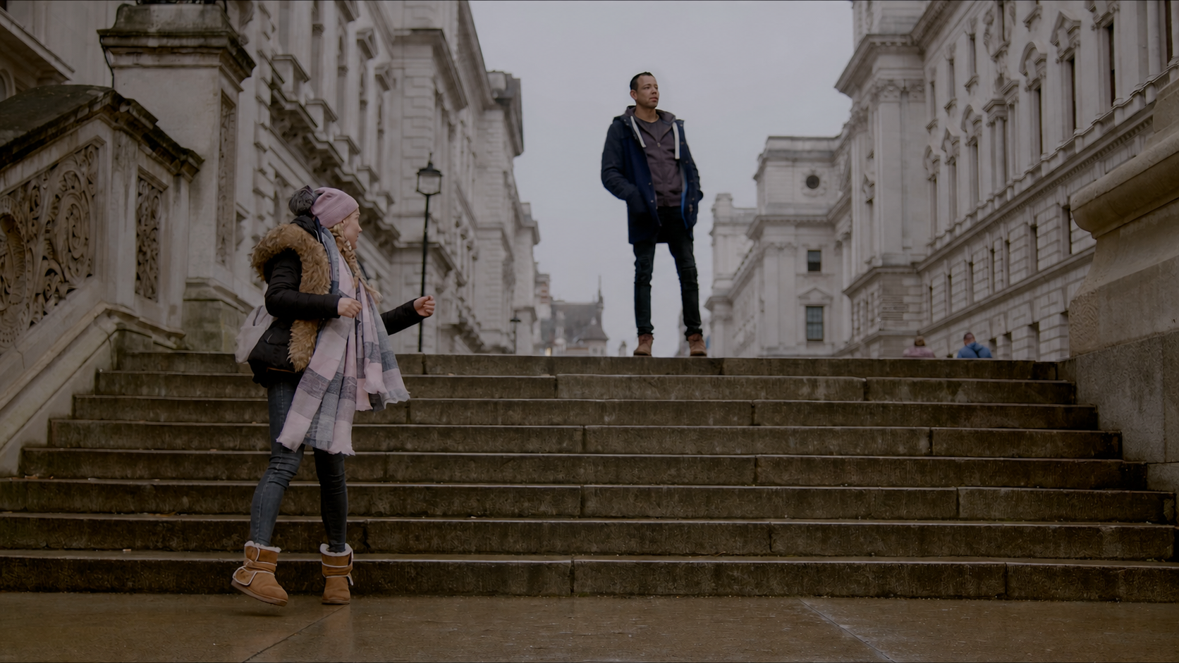 Kian and Hanna separated on a broad staircase in London
